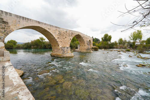 Seljuk bridge in Aspendos. The Eurymedon Bridge. Aspendos Yolu Belkis Mevkii. Turkey. Crooked bridge. Bridge over the Kopruchay (Euremedon) River near Aspendos, in Pamphylia, in southern Anatolia