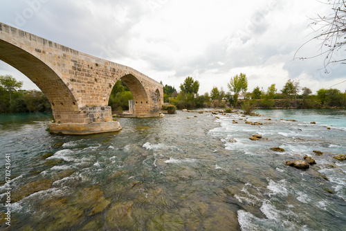 Seljuk bridge in Aspendos. The Eurymedon Bridge. Aspendos Yolu Belkis Mevkii. Turkey. Crooked bridge. Bridge over the Kopruchay (Euremedon) River near Aspendos, in Pamphylia, in southern Anatolia photo