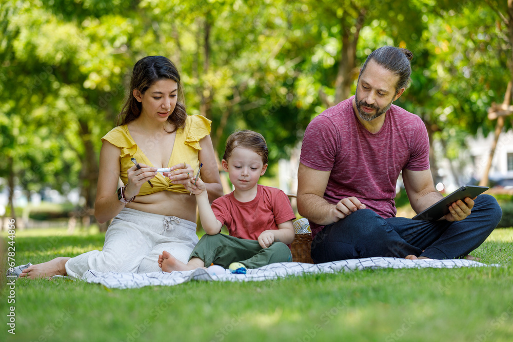 Happy family day, father, mother, son, Caucasian enjoying watercolor painting and picnic in nature. Happy family day, father, mother, son, Caucasian enjoying watercolor painting and picnic in nature.