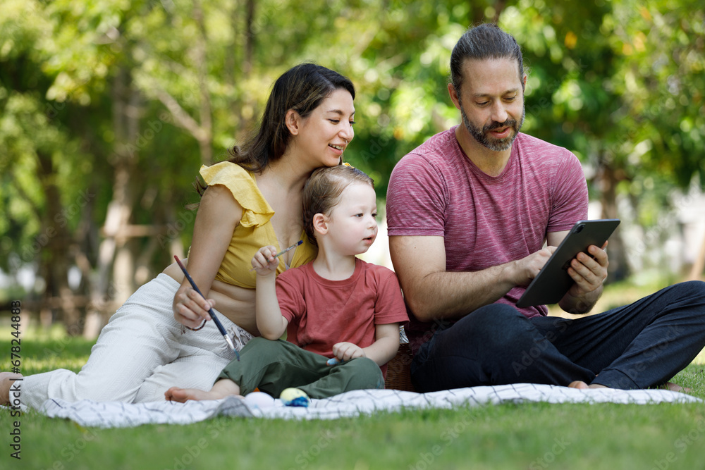 Happy family day, father, mother, son, Caucasian enjoying watercolor painting and picnic in nature.