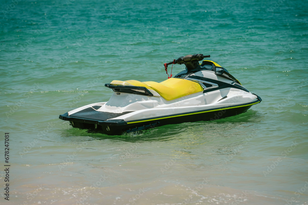 White yellow jetski close to seashore ready to drive, sunny day, tropical water sports. White yellow jetski close to seashore ready to drive, sunny day, tropical water sports.