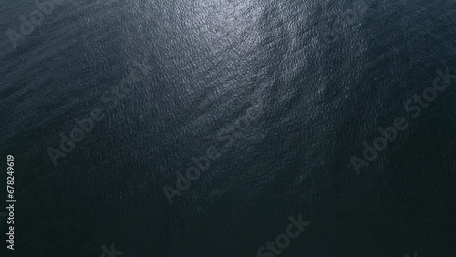 Aerial view of the sea surface reflecting the sun photo