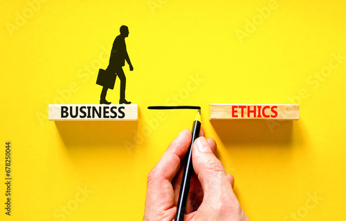 Business ethics symbol. Concept words Business ethics on beautiful wooden blocks. Businessman icon. Beautiful yellow table yellow background. Business ethics concept. Copy space. photo