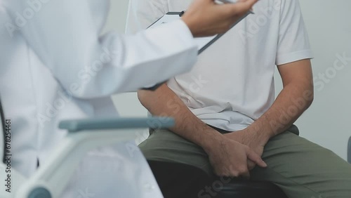 Man with benign prostatic hyperplasia being examined and consulting Asian female doctor and The doctor will ask about the patient's illness and give health advice. photo