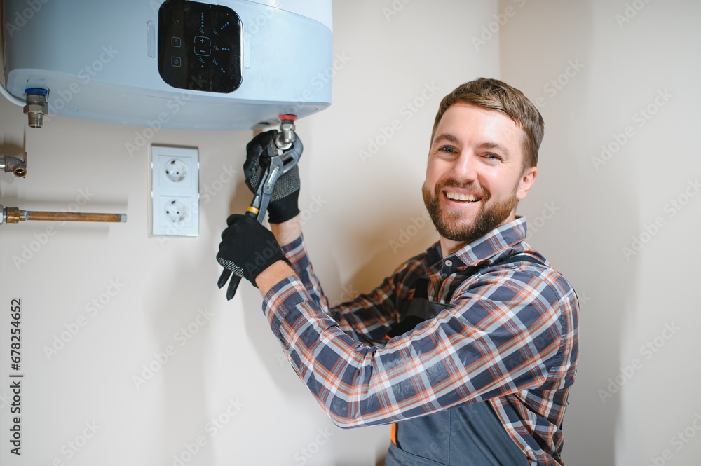 Professional plumber checking a boiler and pipes, boiler service concept Professional plumber checking a boiler and pipes, boiler service concept