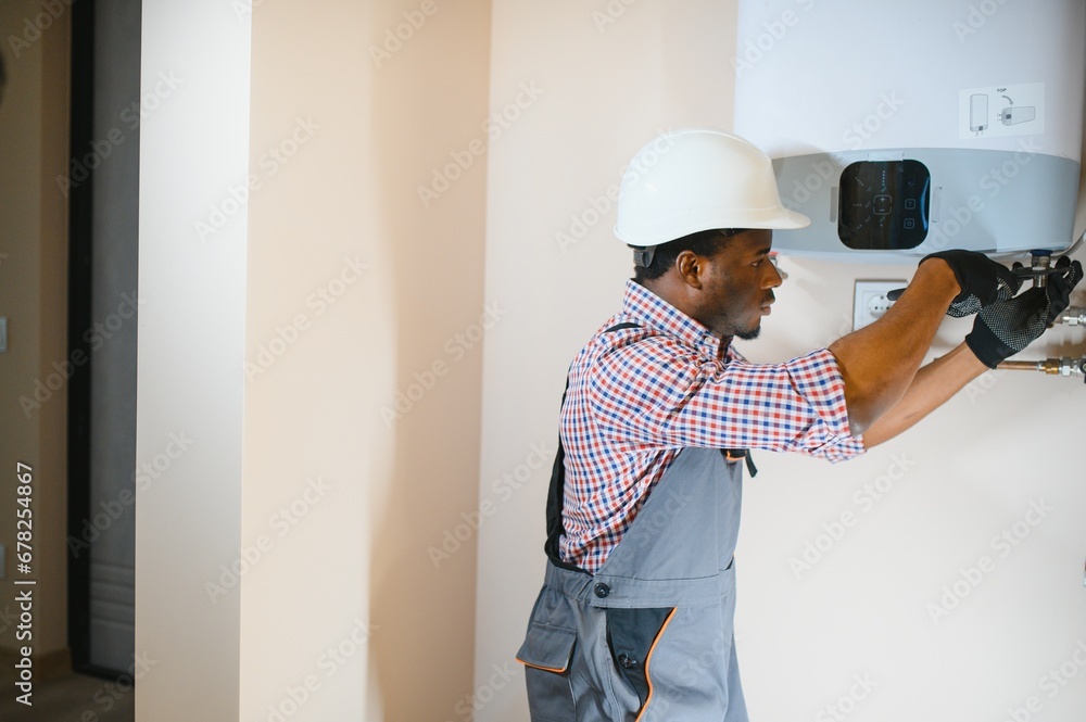 African american worker set up central gas heating boiler at home African american worker set up central gas heating boiler at home