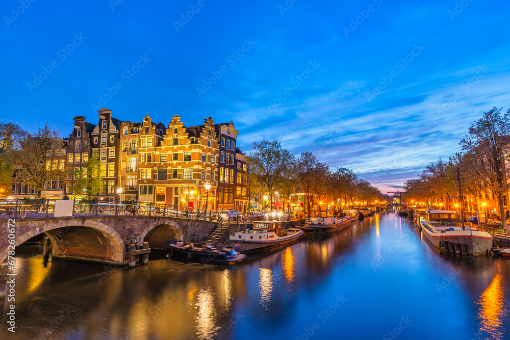 Amsterdam Netherlands, night city skyline at canal waterfront