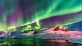 A northern light show illuminates the arctic sky, painting the landscape in shades of green and pink, on top of snow-capped mountains , wide view