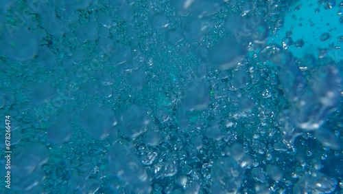 Closeup shot of numerous microbubbles floating underwater photo