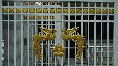 Golden phoenix and Rose of Sharon pattern decoration at the entrance gate of the Blue House in Korea photo