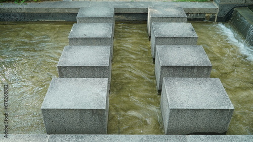 Stone stepping stones in the public park fountain