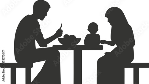 A family sitting around a table eating Eid food icon
