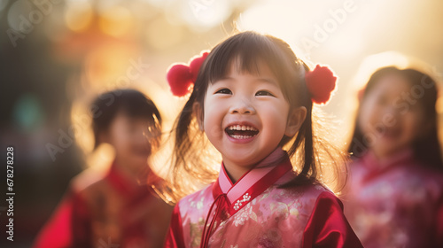 Young children wearing traditional Chinese outfits, playing and laughing, Chinese new year