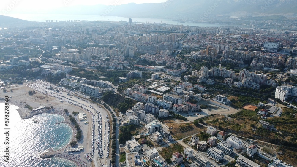 Aerial shot of a modern city and a public beach during the daytime