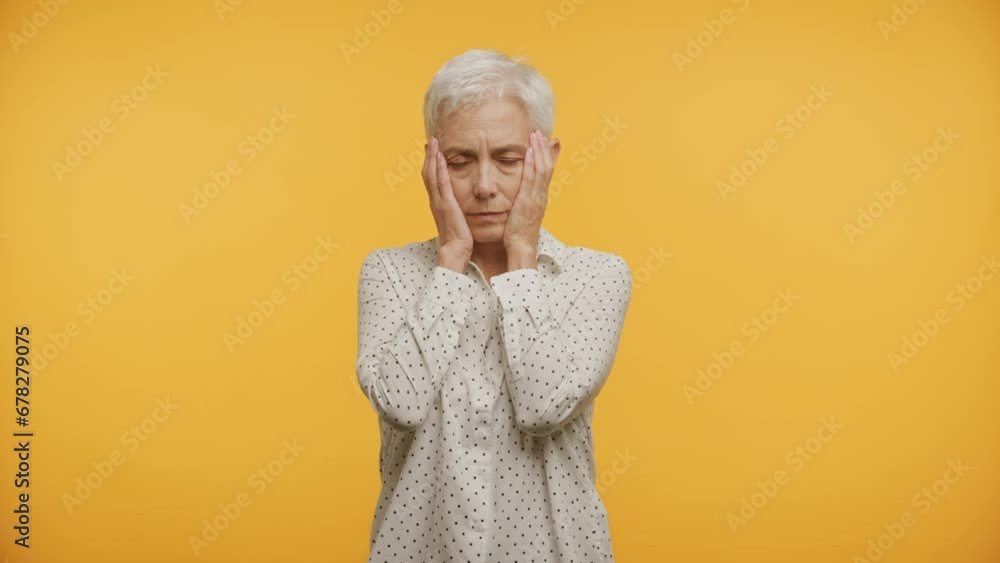 Pensive Mature Woman on Yellow Background Pensive Mature Woman on Yellow Background