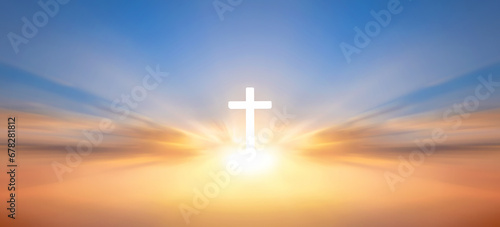 White shining Christian cross on the orange cloudy sky background photo