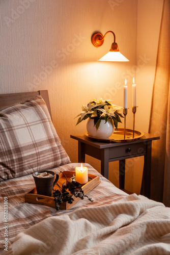 cozy scandinavian bedroom interior in natural tones, blanket candles houseplants