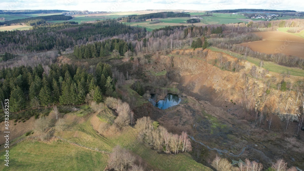 Drone shot over green fields with autumn trees at countryside on a sunny day Drone shot over green fields with autumn trees at countryside on a sunny day