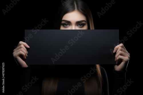 Young woman holding a blank sign, excited woman holding empty blank board for black friday advertising and markting banner, poster photo