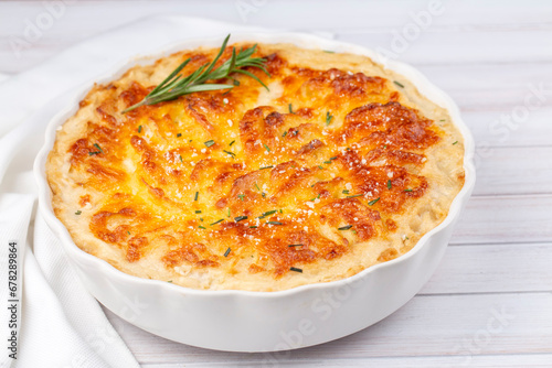 Potato gratin - graten (baked potatoes with cream and cheese) with rosemary and forks (Turkish name; Kremali patates) photo