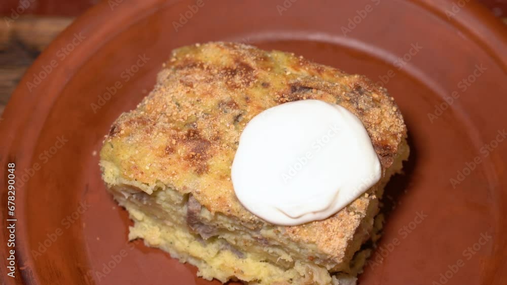 vegetarian casserole with sour cream on a plate. High quality 4k footage vegetarian casserole with sour cream on a plate. High quality 4k footage