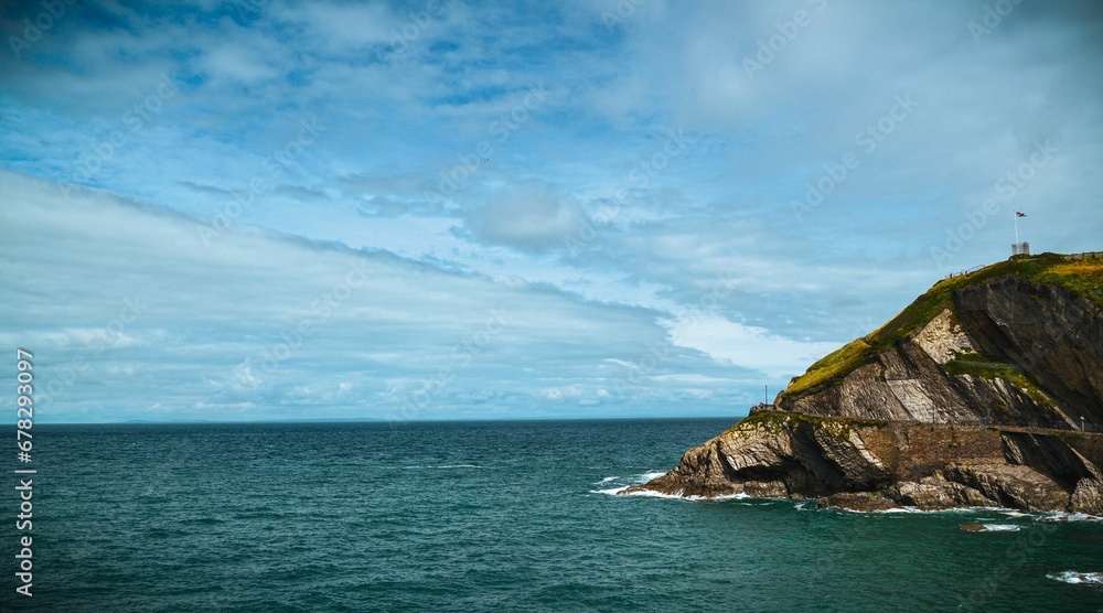 Scenic view of a coastal cliff with a beautiful seascape visible in the background