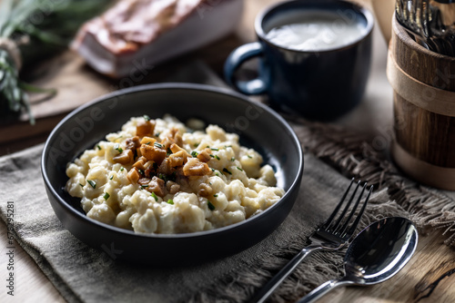 Fotografija Halusky as traditional Slovak potato gnocchi with sheep cheese bryndza, fried ba
