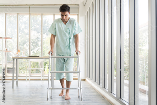 Patient man using walker at hospital ward. Patient man using walker for walk in hospital room