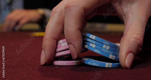 Hands of a young caucasian man playing poker in a casino