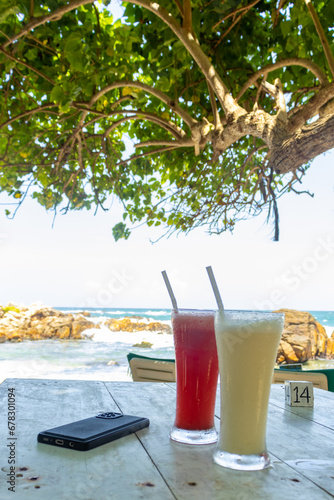 Refreshing drinks in the middle of scorching sun. Secret beach, Mirissa Sri Lanka. Relaxing under the shade of a tree with delicious drink on the perfect summer day. 
