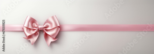 Banner Pink ribbon and bow on white background. Simple pink bow. Decoration for girls, hair care. Items for everyday use, creating stylish and bright look for baby. Modern style, fashion, decorative  photo
