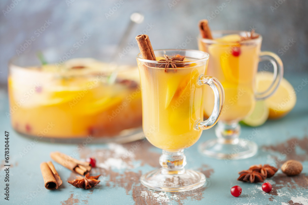 Homemade hot alcohol mulled apple cider punch with cinnamon sticks, anise star and spices