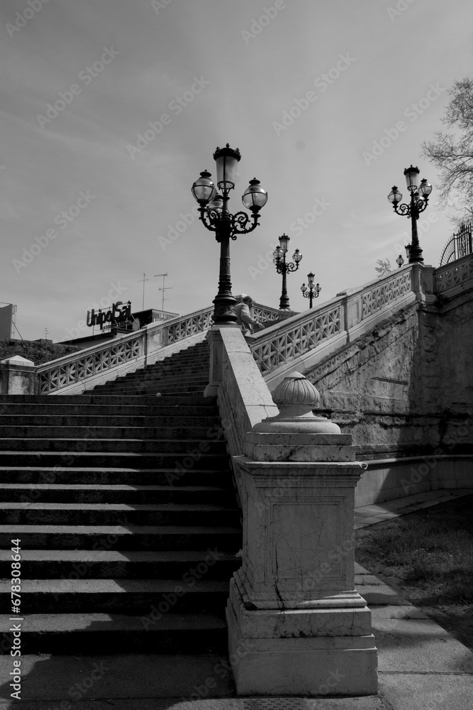 Fototapeta premium Stairs of Pincio in Italy. Old stairs in the park. Italian style garden over a hill in the city center. Black and white old building. 