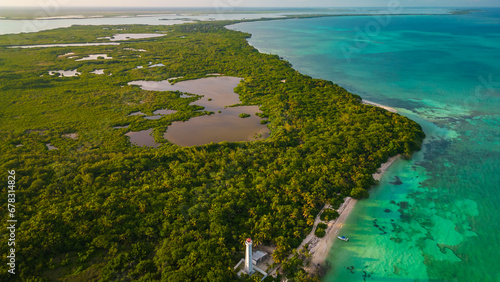 drone fly above natural park biosphere reserve in Tulum Sian Ka an aerial high angle of punta Allen lighthouse