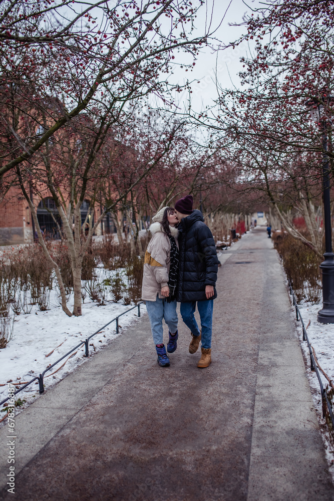 Fototapeta premium Couple in love in winter on Christmas eve walking