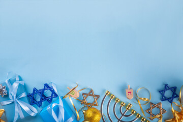 Happy Hanukkah greeting card background. Jewish New Year holiday flat lay with traditional symbols of hanukkah festival, menorah, donuts and decorations copy space