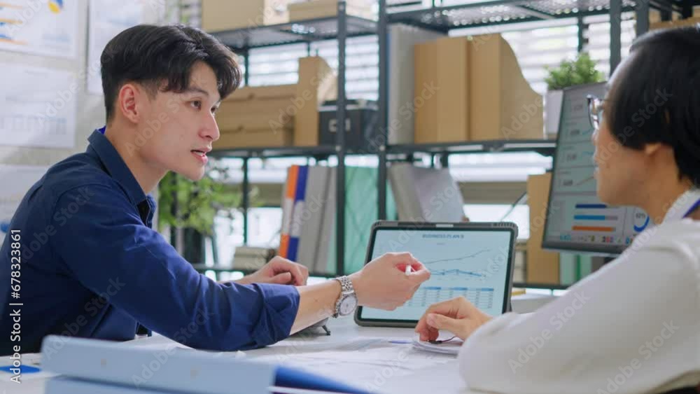 young asian businessman presentation with digital tablet to a Manager in company office.Teamwork,collaboration and brainstorming,strategy and goal,mentor coach,worker learn new skills in office. young asian businessman presentation with digital tablet to a Manager in company office.Teamwork,collaboration and brainstorming,strategy and goal,mentor coach,worker learn new skills in office.
