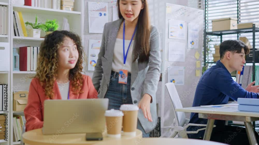 two asian female creative agency casual meeting discussion working with laptop in coworking space.Helpful asian female mentor coach intern new businesswoman to worker learn new skills in office.