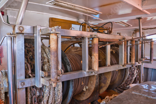 Steel cable winch in a fishing ship photo