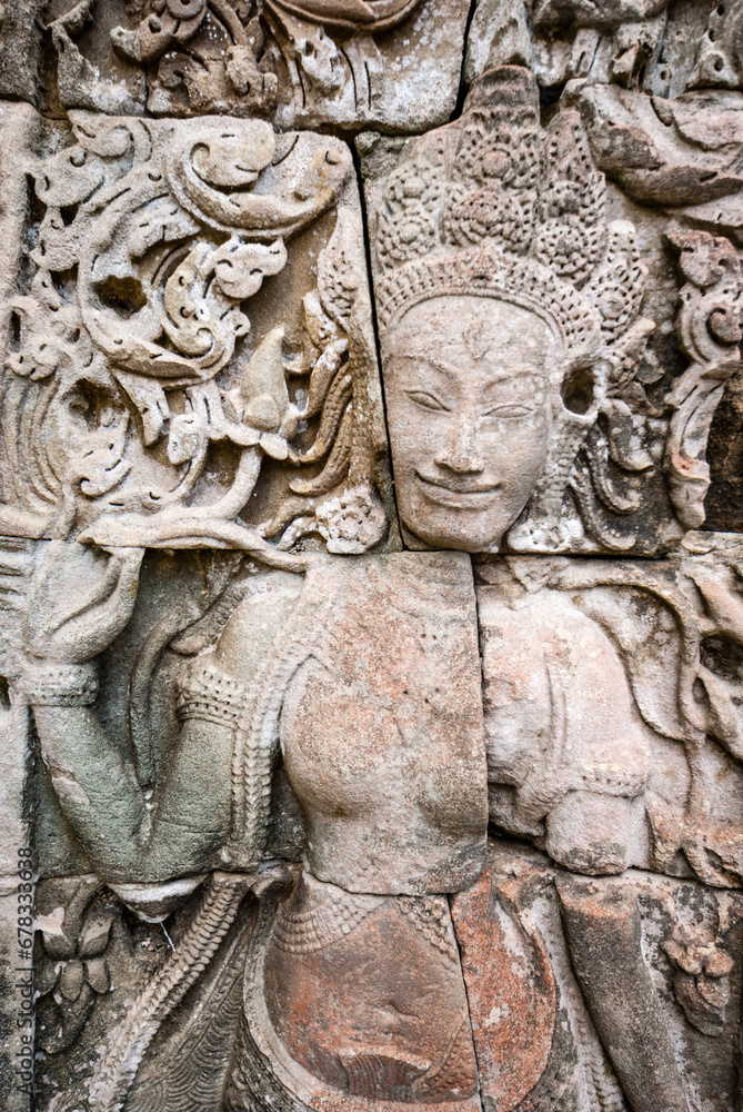 Female sculpture on the facade of Angkor Thom Bayon, Angkor. Cambodia, Asia
