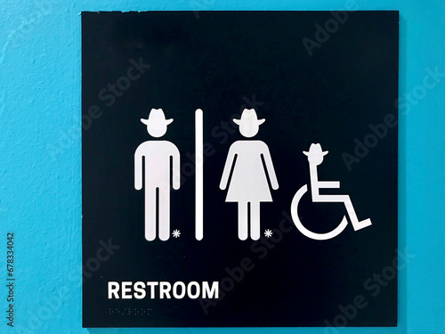 restroom sign with cowboy & cowgirl symbols