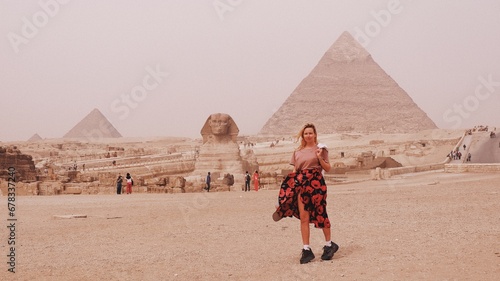 European woman a front of Giza pyramid in Cairo Egypt travel photography  photo