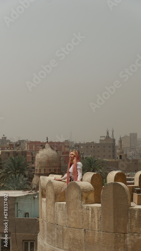 Woman tourist in Bab Zuweila historical landmark in Cairo Egypt 