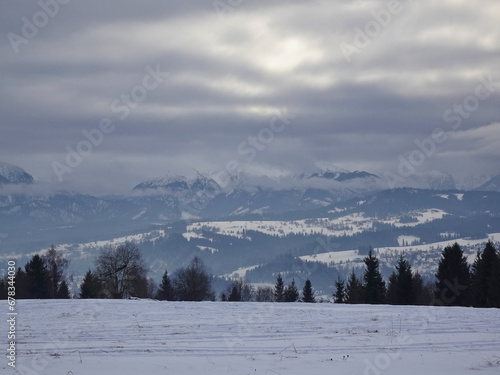 View of the snow-covered Tatra Mountains and Bukowina Tatrzanska on a cloudy and cold winter day, Bukowina Tatrzanska, Tatara Mountains, Poland.