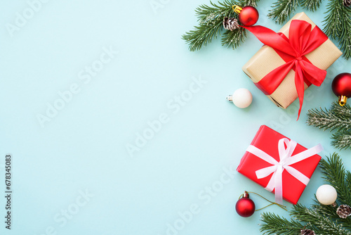 Christmas background. Christmas present box and decorations at blue. Flat lay image with copy space.