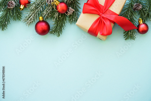 Christmas background. Present box and red decorations at blue background. Flat lay image with copy space.