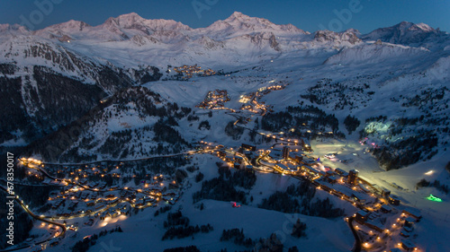 Alpine resort lights twinkle at twilight.
