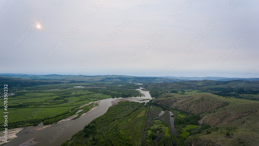 Sweeping Mongolian landscape with forested hills Sweeping Mongolian landscape with forested hills