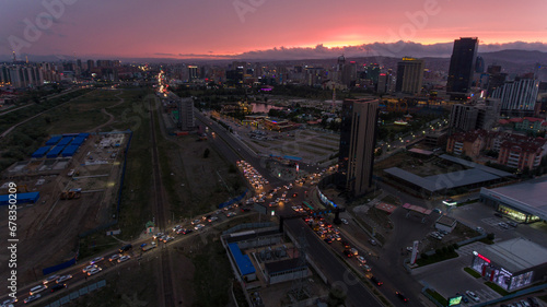 Sunset over Ulaanbaatar with a ferris wheel silhouette.