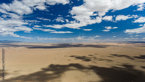 Vast desert plain under Mongolia's cloud-filled sky.